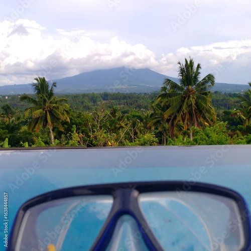 Scenic View of Mountain and Tropical Trees Reflected in Clear Water Surface