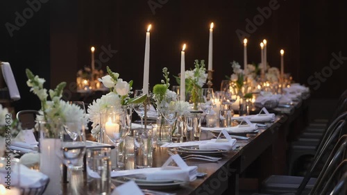 The event space is beautifully arranged with floral centerpieces and soft lighting for a warm ambiance