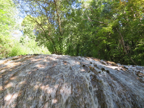 beautiful waterfall forming a river of reflections, soothing sound