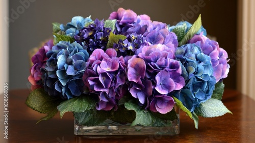 Hydrangeas Arranged Beautifully in a Glass Vase on a Wooden Table