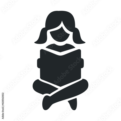 Silhouette of young female reading book in seated position