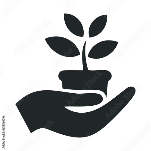 Silhouette of hand holding potted plant symbolizing growth and care