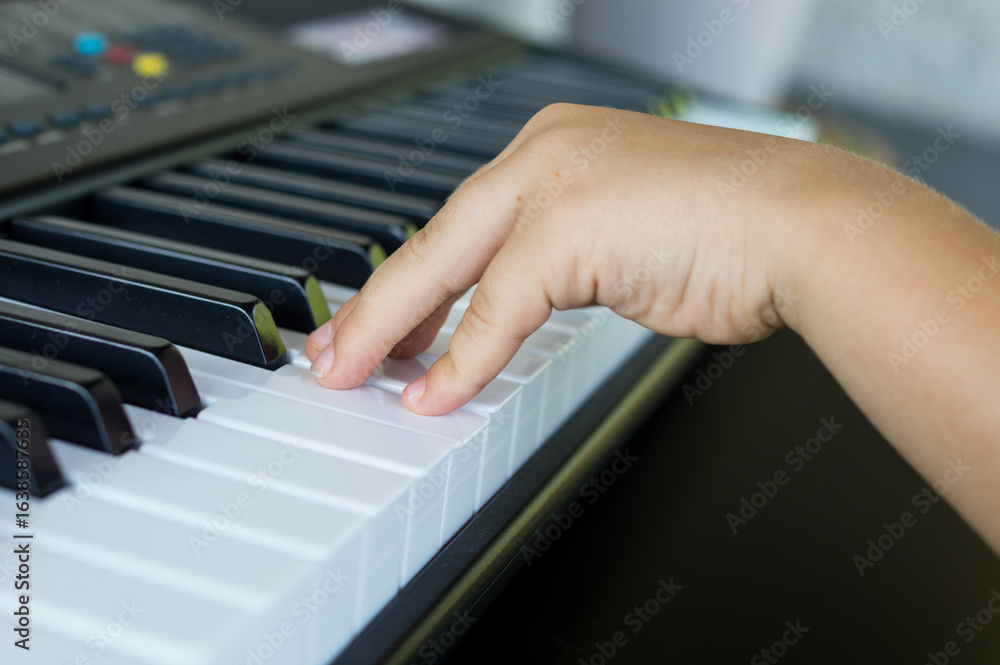 Obraz premium Little boy taking piano lessons