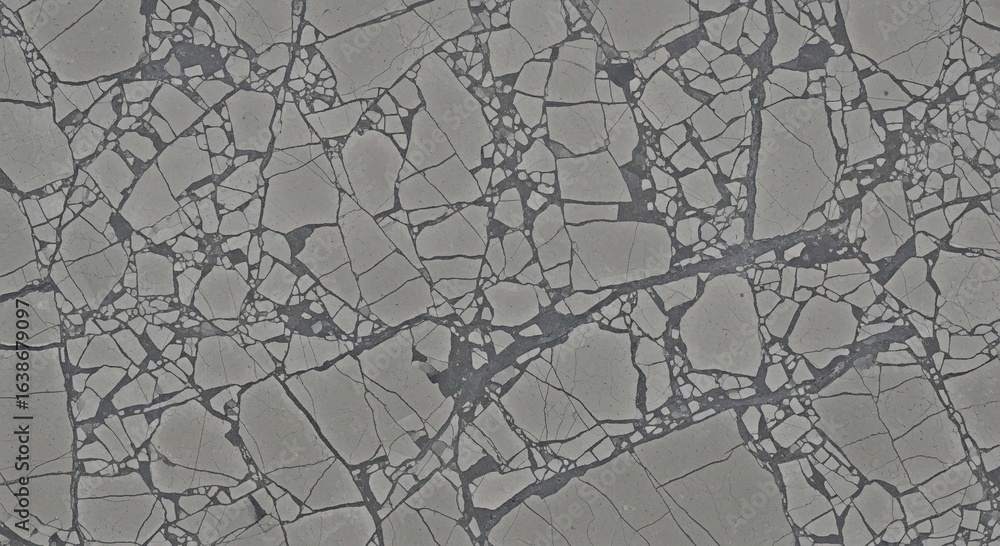 An aerial view of shattered and cracked sea ice floes creating a complex, abstract pattern on the ocean. An aerial view of shattered and cracked sea ice floes creating a complex, abstract pattern on the ocean.