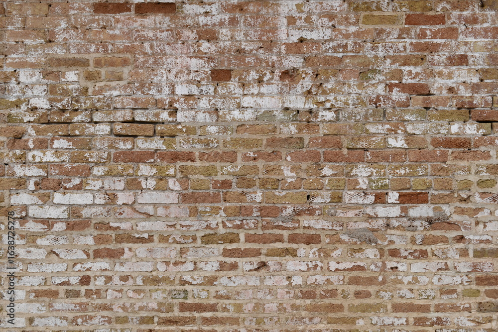 Very old red brick wall. Faded, cracked and crumbling with time. Very old red brick wall. Faded, cracked and crumbling with time.