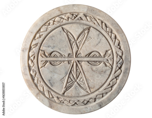 Ancient Chi Rho symbol carved into marble, representing faith and history