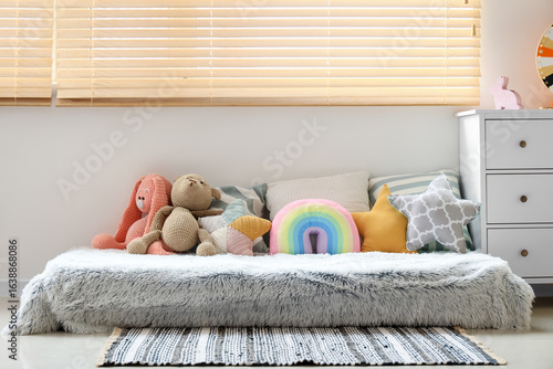 Bed with pillows and toys i...