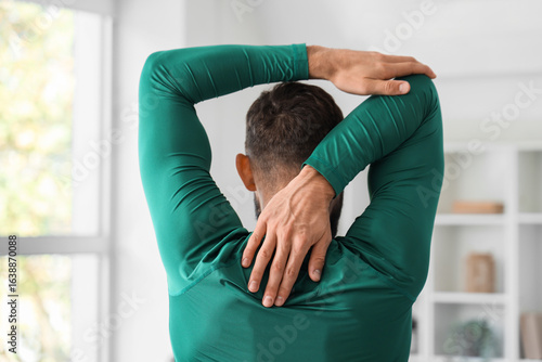 Man in green sportswear str...