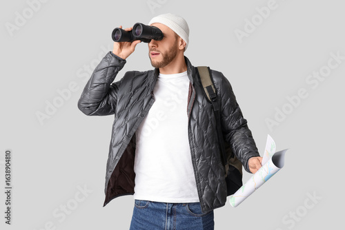 Young male tourist with bac...