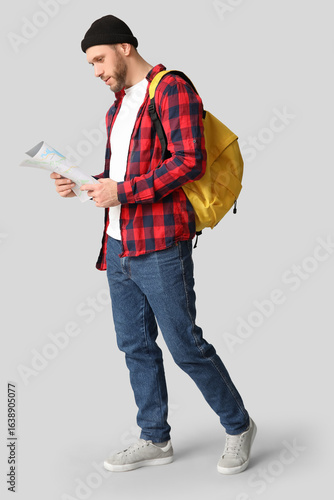 Young male tourist with bac...