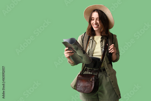 Female traveler with map on...