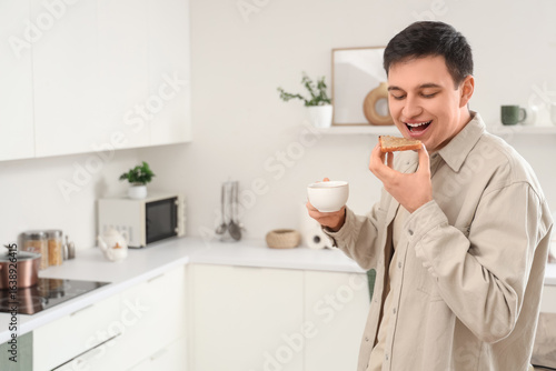 Young man holding toast wit...