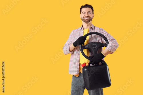 Young man with car steering...