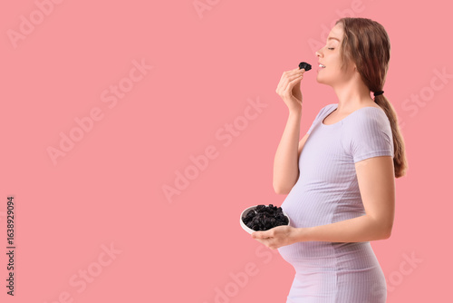 Young pregnant woman eating...