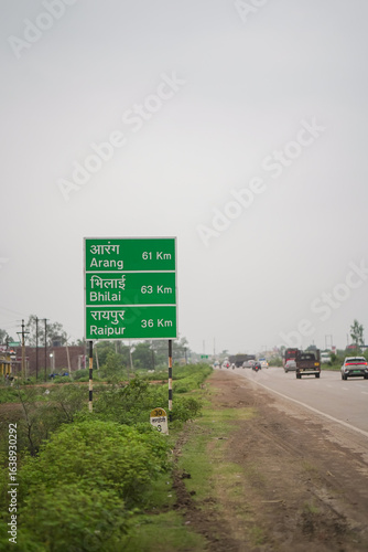 Photography indian highway distance signboard, green road direction sign india, national highway travel guide board, rural expressway milestone signage stock photo