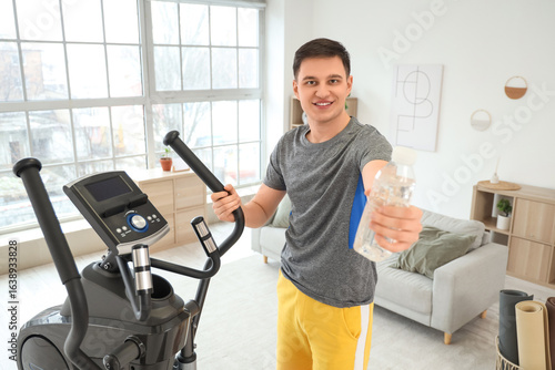 Sporty young man with water...