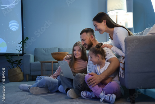 Happy family with laptop wa...