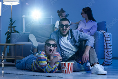 Happy family with 3D glasse...