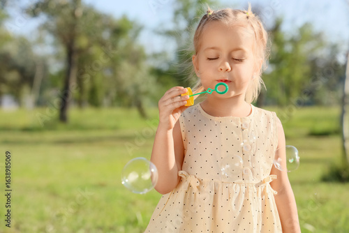 Cute little girl blowing so...