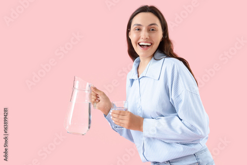 Young woman with jug and gl...