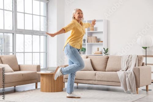 Mature woman dancing at home