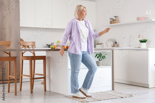 Mature woman dancing in kit...