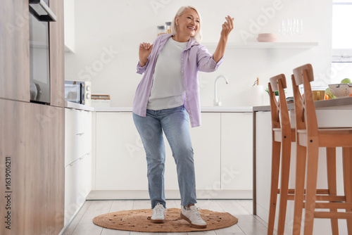 Mature woman dancing in kit...