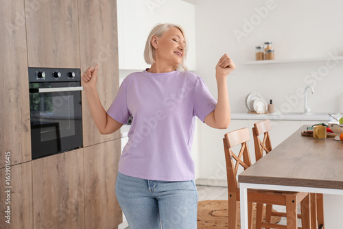 Happy mature woman dancing ...