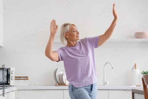 Happy mature woman dancing ...