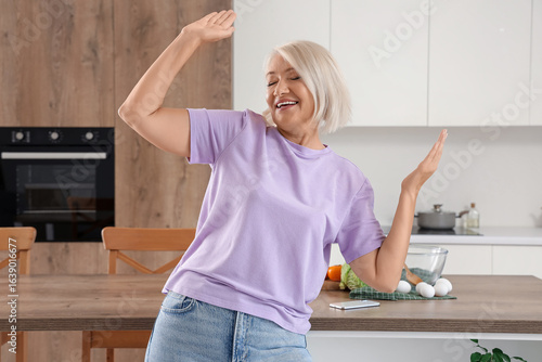 Happy mature woman dancing ...