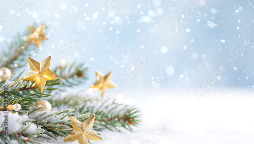 Golden stars on snowy pine branches christmas