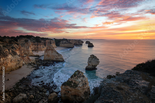 Morning at Praia d Marinha at the Algarve coast in Portugal. Beautiful sky and rock formations.
