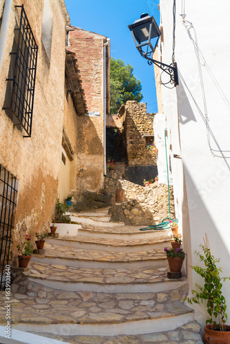 Town street decorated with flowers, in Molinicos village, Castilla la Mancha, Spain.