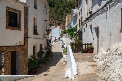 Town street decorated with flowers, in Molinicos village, Castilla la Mancha, Spain.