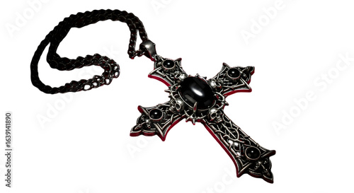 A gothic cross pendant with black stones and skulls on a silver chain against a black background