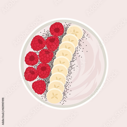 Smoothie bowl with fresh raspberries and sliced banana on pink backdrop. A healthy smoothie bowl filled with vibrant fruit and nutritious chia seeds.