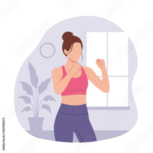 Woman doing fitness at home with boxing stance near window and indoor plant. Fitness at home workout includes focus on health and well being.