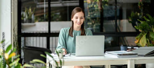 Young Professional European Woman Working Online at Home Smiling Using Laptop Computer Doing Remote Work Concept For Business and E-Commerce