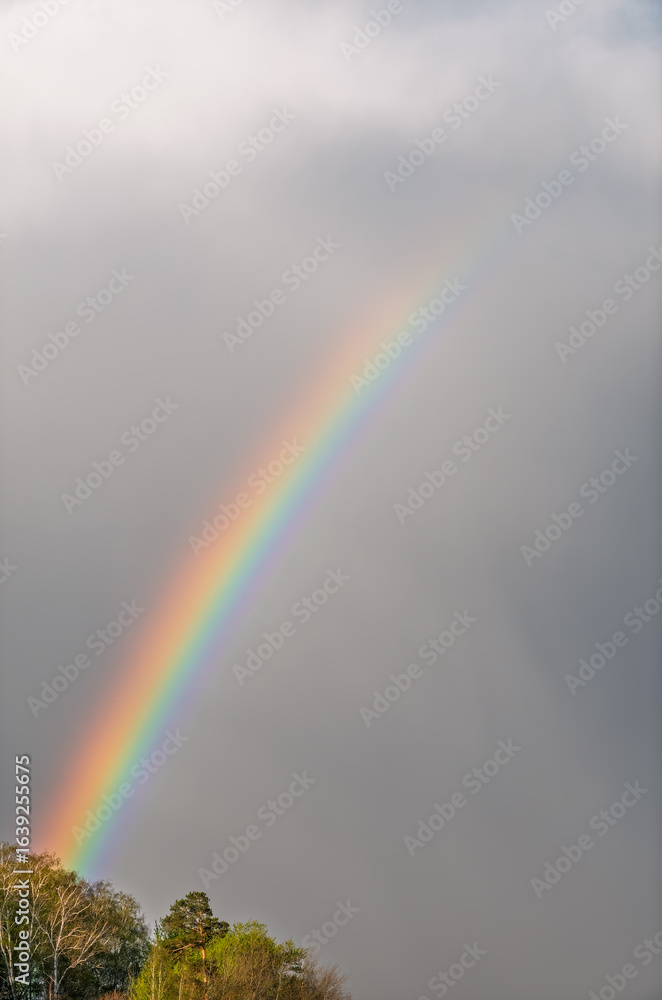 Fototapeta premium Rainbow over Blue lake with cloudy sky