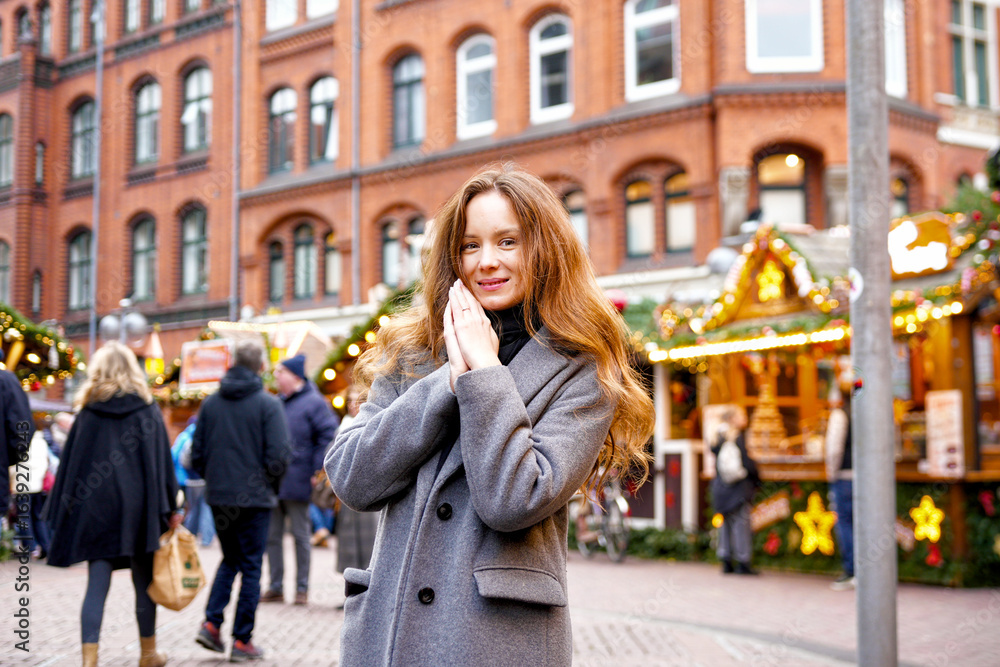 Fototapeta premium Young woman enjoying Hanover festive Christmas market outdoors