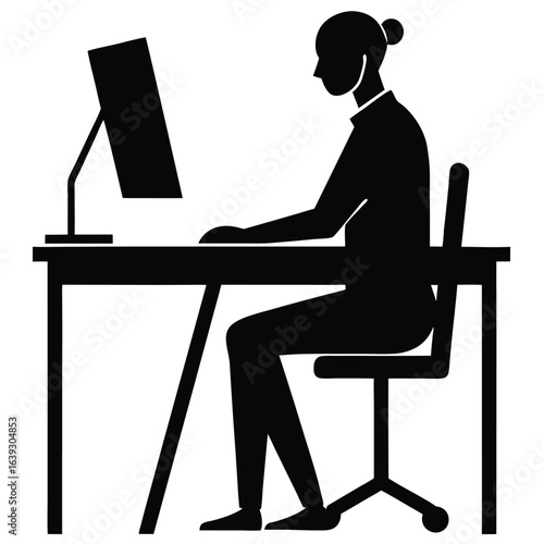 Silhouette of person working remotely at desk with laptop