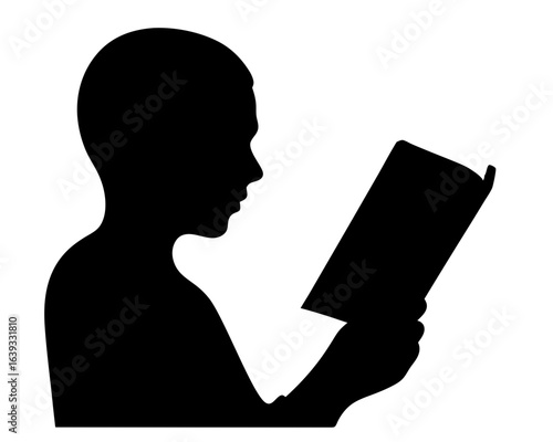 Black silhouette of a young boy reading a book with concentration