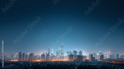 Wallpaper Mural Serene cityscape at night bathed in soft, glowing lights. Skyline of modern skyscrapers against a clear, dark blue sky. Perfect for urban, business, and travel themes. Torontodigital.ca