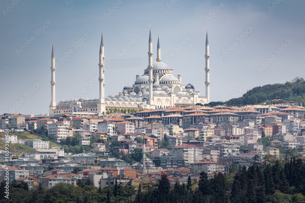 Naklejka premium Cityscape with big mosque and six minarets on hilltop above city on sunny day, Istanbul, Turkey