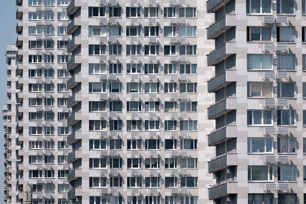 Obraz premium Row of same high rise boring brutalist grey concrete office buildings on sunny day, Moscow, Russia