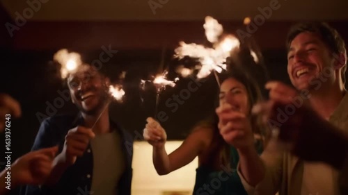 A group of joyful celebrates with sparkling pyrotechnics, creating a festive atmosphere of happiness and excitement at night.