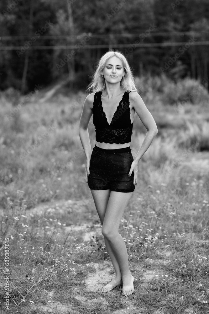 Portrait of a young beautiful blonde girl in light clothes outdoors in summer. Black and white photo. Portrait of a young beautiful blonde girl in light clothes outdoors in summer. Black and white photo.