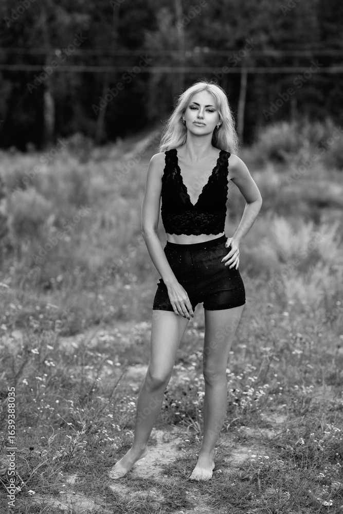Portrait of a young beautiful blonde girl in light clothes outdoors in summer. Black and white photo. Portrait of a young beautiful blonde girl in light clothes outdoors in summer. Black and white photo.