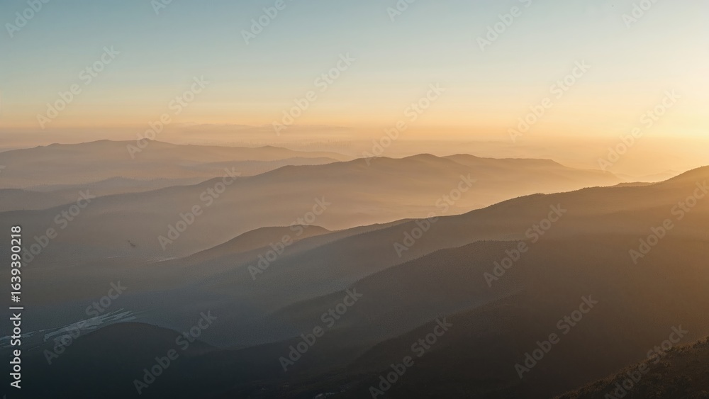 Obraz premium Behold the tranquil morning scene where soft sunlight caresses mist-veiled mountains and peaceful valleys below.