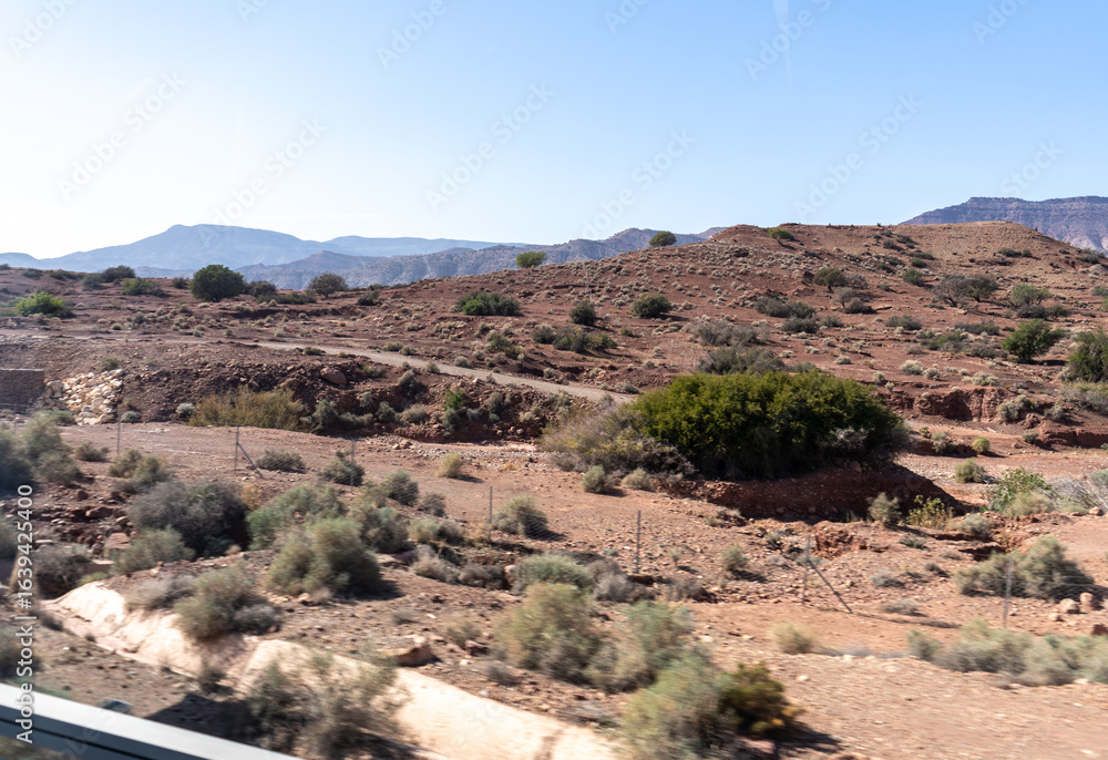 Obraz premium Morocco semi-deserts and mountains, north africa nature, Moroccan stone desert, red hills, villages and argan trees